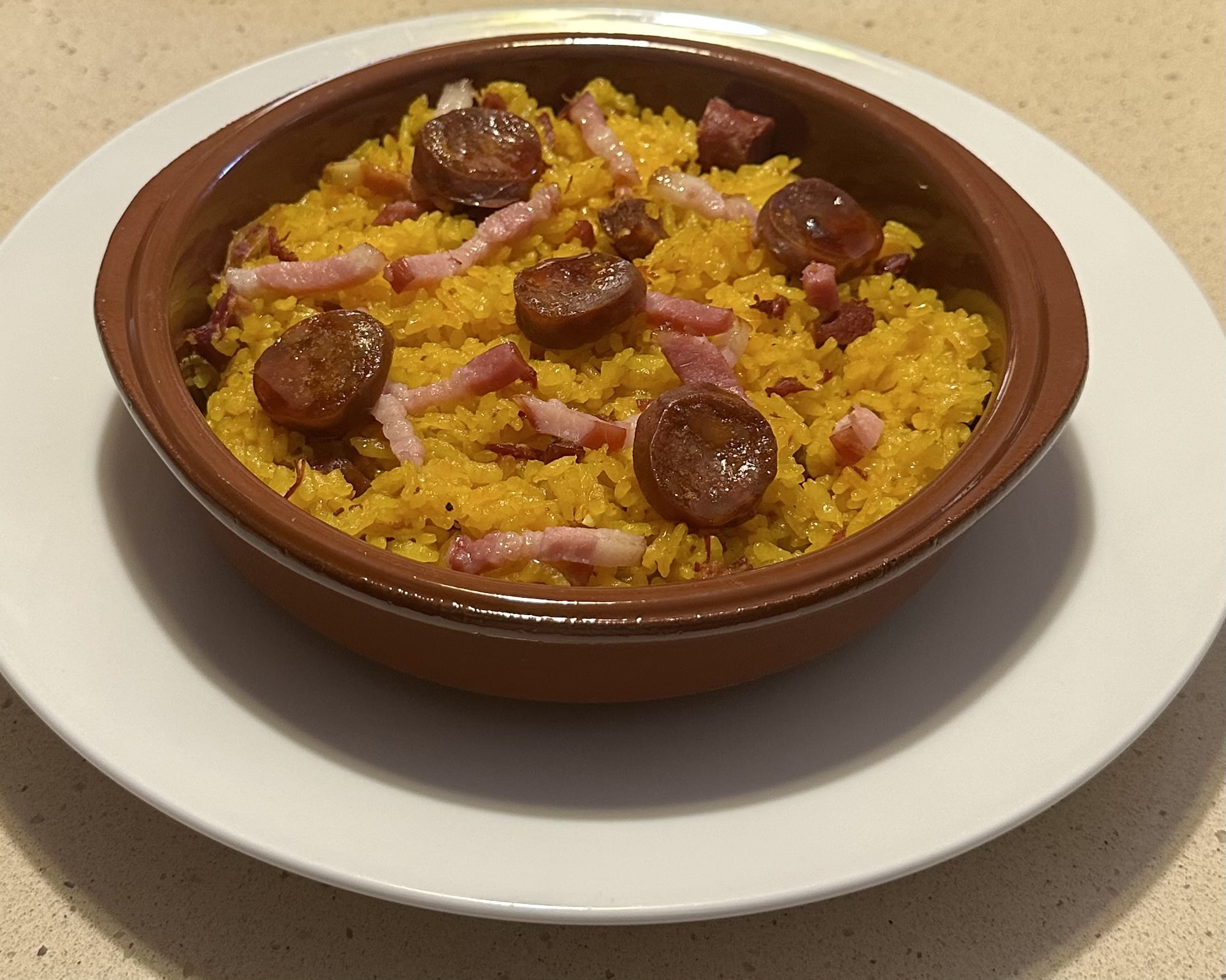 a bowl of rice with sausages and bacon